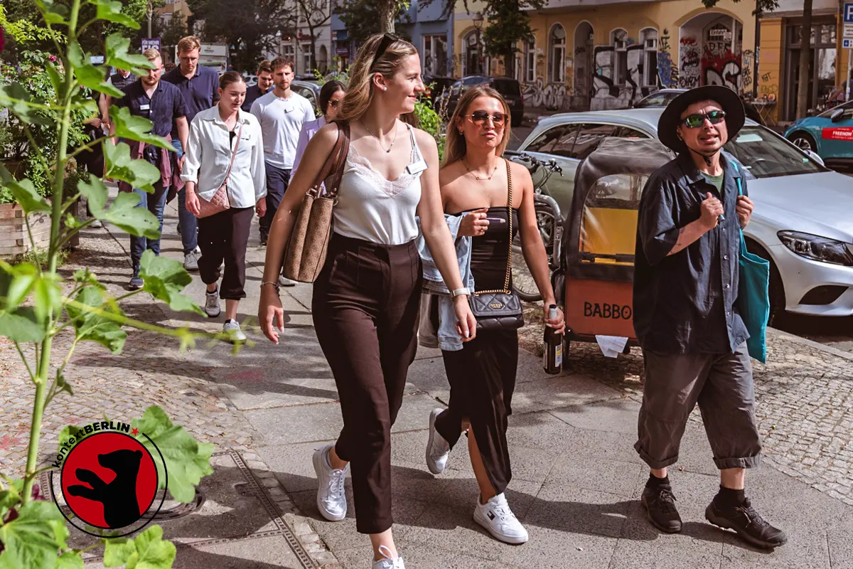 Lee walking with a group of tour guests