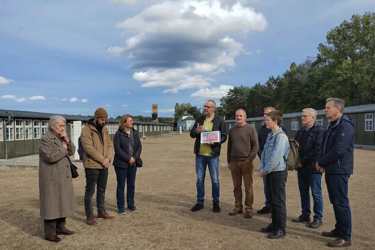 Klaus with a visitor group between the Infirmary Baracks at the Museum and Memorial Site Sachsenhausen